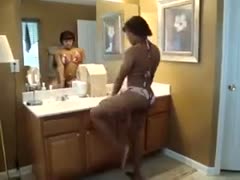 In the bathroom, the black, booty-licious sweetie gets undressed.